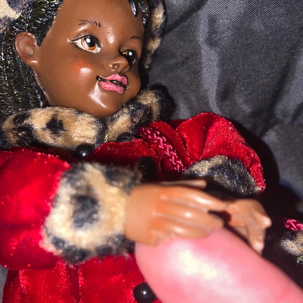 Vintage African American doll ornament with red velvet and leopard fur purse